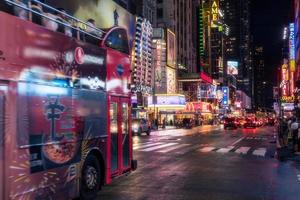 New York City, USA - August 9, 2019-People and tourists stroll among the lights and skyscrapers of Time Square in Manhattan during a summer night photo