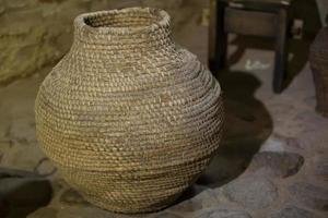 Old wicker vine container jug for wine. photo