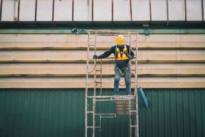 Construction worker wearing safety harnesses on Scaffolding at construction site. working at heights above ground ,Safe working for Scaffolding concept photo