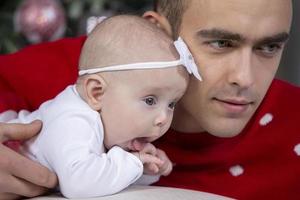 Handsome young father with his newborn daughter. photo