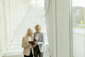 Business women walking in the office corridor photo