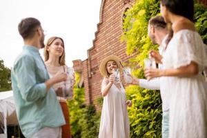 A group of young people gather outdoors to enjoy each other's company and refreshing glasses of lemonade photo