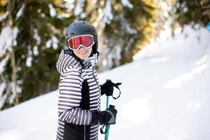 Young woman enjoing Winter Day of Skiing Fun in the Snow photo