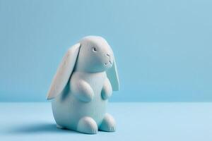 Wooden lop eared bunny on light blue background. . photo