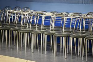 Many chairs stand in a row. photo