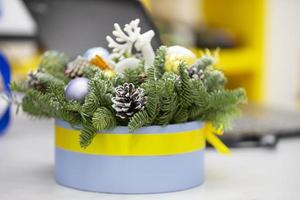 Cardboard box with fir branches and cones. Christmas decoration. photo