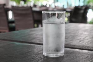 Glass of cold water on table photo