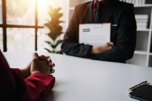 Close up view of job interview in office, focus on resume writing tips, employer reviewing good cv of prepared skilled applicant, recruiter considering application, hr manager making hiring decision photo