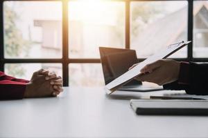 Close up view of job interview in office, focus on resume writing tips, employer reviewing good cv of prepared skilled applicant, recruiter considering application, hr manager making hiring decision photo