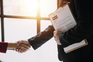 Close up view of job interview in office, focus on resume writing tips, employer reviewing good cv of prepared skilled applicant, recruiter considering application, hr manager making hiring decision photo