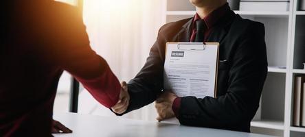 Close up view of job interview in office, focus on resume writing tips, employer reviewing good cv of prepared skilled applicant, recruiter considering application, hr manager making hiring decision photo