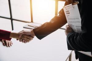 Close up view of job interview in office, focus on resume writing tips, employer reviewing good cv of prepared skilled applicant, recruiter considering application, hr manager making hiring decision photo