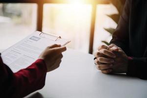 Close up view of job interview in office, focus on resume writing tips, employer reviewing good cv of prepared skilled applicant, recruiter considering application, hr manager making hiring decision photo
