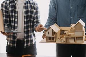 Image of engineering objects on workplace with three partners interacting on background photo