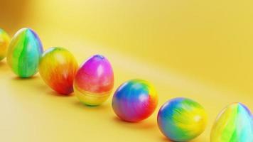 Multicolored Easter eggs roll on a yellow background. Loop animation video