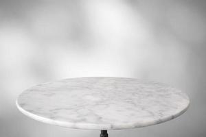 Marble table with tree shadow drop on white wall background for mockup product display photo