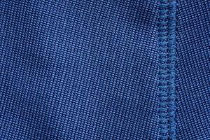 Blue sports clothing fabric football shirt jersey texture with stitches photo