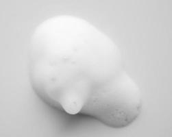 Abstract white soap foam bubbles texture on white background photo