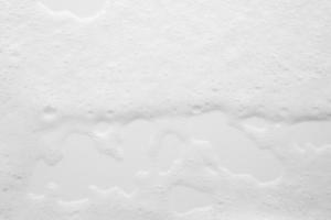 Abstract white soap foam bubbles texture on white background photo