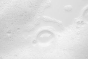 Abstract white soap foam bubbles texture on white background photo