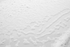 Abstract white soap foam bubbles texture on white background photo