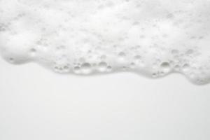 Abstract white soap foam bubbles texture on white background photo