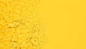 Yellow Abstract water background texture with ripples and waves photo