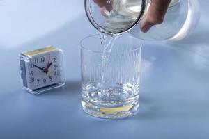 Detail of person filling glass of water. hydration concept photo