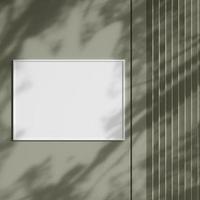 Blank picture frame hanging on the wall with shadow. Empty poster mockup for art display in sunlight. Minimal interior design. photo