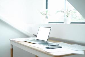 Mockup image of laptop on wood table with equipment of the mobile application graphic designer, mockup concept photo