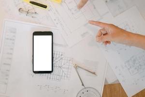 Mockup image of engineers tools with blueprint and calculator on wood table in the office, mockup concept photo