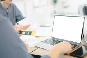 Mockup image of engineers using laptop to drawing design building Project in office, mockup concept photo