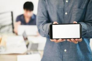 Mockup image of engineers showing smartphone design building Project in office, mockup concept photo