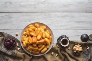 Arabic sweets Tulumba, celebration Eid Ramadan. Tulumba- arabian syrup-soaked fried sponge honey. photo