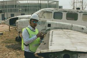 Aircraft mechanic examining airplane wing photo