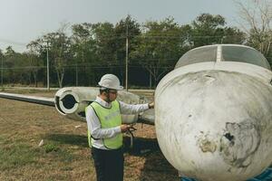 Aircraft mechanic examining airplane wing photo