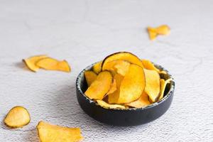 Sliced dried sweet potato in a bowl on the table. Homemade snack photo