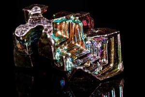 Macro mineral stone Bismuth on black background photo