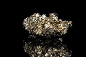 Macro mineral stone Pyrite on a black background photo