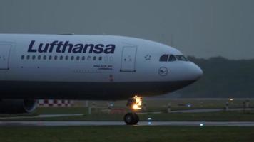 DUSSELDORF, GERMANY JULY 24, 2017 - Lufthansa Airbus 330 D AIKG taxiing after landing at rain early morning. Dusseldorf airport, Germany video