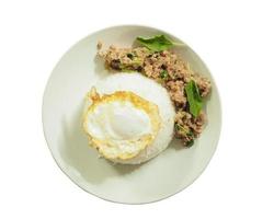 White plate with steamed rice, stir fried with basil and pork Top view isolated from white background photo
