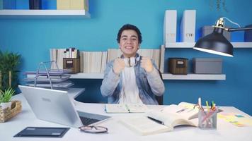 The student who looks into the camera waiting for something he wants to happen and is happy when he gets what he wants. video