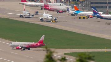 SOCHI, RUSSIA JULY 29, 2022 - Passenger plane of Rossiya airline on the runway at Sochi airport. Jet plane on the airfield video