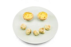 Baked Egg tarts and  choux dough on white background photo