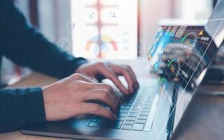 Analyst working with Business Analytics and Data Management System on computer, make a report with KPI and metrics connected to database. Corporate strategy for finance, operations, sales, marketing photo