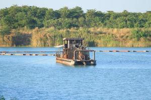 Sand suction vessels are transporting sand from steel pipes in deep rivers for the construction of industries such as houses, buildings, roads and many others where sand is used as a mixture. photo