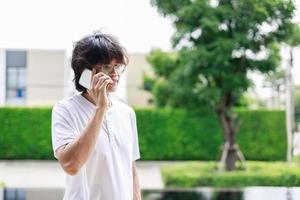 Technology on Vacation, Man Uses Smartphone to Work Remotely by the Pool in Resort Hotel photo