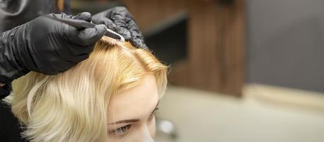 Young woman receiving dyeing hair photo