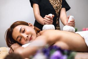 Beautiful woman doing Thai massage in spa photo