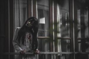 Portrait of asian woman make up ghost,Scary horror scene for background,Halloween festival concept,Ghost movies poster,angry spirit in the apartment photo